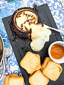 Melted Alentejo cheese with bread and jam