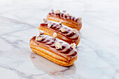 Eclairs with chocolate icing and nuts