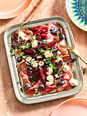 Beef carpaccio with roasted beetroot, blueberries and micro greens