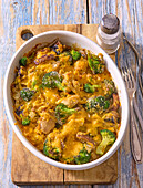 Oven-baked chicken casserole with broccoli and mushrooms