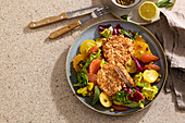 Citrus salad with breaded pork schnitzel and potatoes