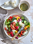 Summer mozzarella vegetable salad with tomatoes, cucumber and raspberries