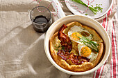 Dutch baby pancake with bacon and fried eggs