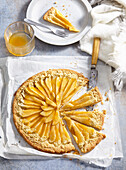 Shortcrust pastry pear galette with apricot jam