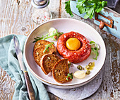 Beef tartare with egg, capers and toasted bread