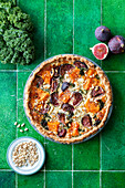 Pumpkin and fig tart with nuts and herbs