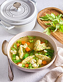 Vegetable soup with cheese gnocchi and fresh herbs