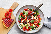 Grilled melon and tomato salad with sheep's cheese