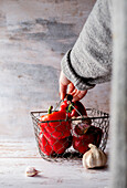 Red peppers and garlic in a wire basket