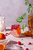 Summer cocktail with raspberries and orange