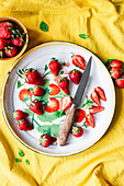 Fresh strawberries on a plate with a knife