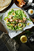 Tortilla wrap with salmon, egg, rocket and mustard-dill sauce