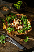 Prawn salad with wild herbs in a tortilla shell