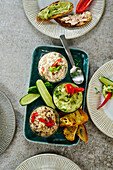 Three spreads with vegetables and toasted bread