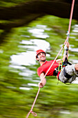 Man dangling from a rope suspended mid air