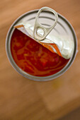 Elevated view of an open tin of tomatoes