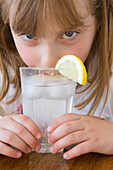 Girl Drinking Water with Ice and Lemon