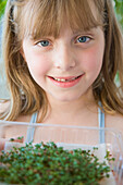 Young Girl Holding Watercress Seedlings