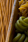 Green and Whole Wheat Pasta in Wooden Drawer