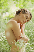 Nude Woman Hugging herself in Meadow