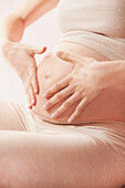 Effleurage Therapeutic Massage, Pregnant Woman Massaging her Stomach