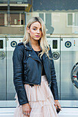 Young Woman Standing Outside Launderette