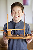 Boy Holding Model Ship