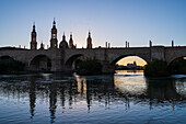 Cathedral-Basilica of Our Lady of the Pillar and the Ebro River bank at sunset, Zaragoza, Spain