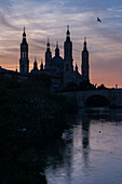 Cathedral-Basilica of Our Lady of the Pillar and the Ebro River bank at sunset, Zaragoza, Spain