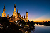 Cathedral-Basilica of Our Lady of the Pillar and the Ebro River bank at sunset, Zaragoza, Spain