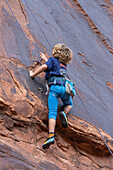 A young boy, age 6, learning to rock climb in Hunter Canyon near Moab, Utah.