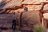 Ein kleiner Junge, 3 Jahre, lernt mit seiner Mutter im Hunter Canyon in der Nähe von Moab, Utah, das Klettern.