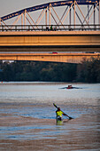 Kayakers at sunset on the Ebro River, Zaragoza, Spain