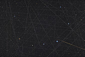 This is a demonstration of the crowded sky we now have, with all the trails being from Earth-orbiting satellites, with the exception of the tapered orange streak at lower right which is likely a meteor. This is a stack of 40 exposures taken over 70 minutes, layered to accumulate the satellite trails, not eliminate them, to show how many satellites crossed the field in the hour plus of the imaging. Are some SpaceX Starlinks? Perhaps, but there are many other satellites up there now.