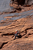 A young boy, age 3, learning to rock climb in Hunter Canyon near Moab, Utah.