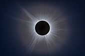 This is a telescopic close-up of the eclipsed Sun at the April 8, 2024 total solar eclipse, with the Sun's intricate atmosphere, the corona, surrounding the dark silhouetted disk of the Moon.