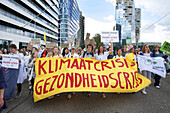 Environmental activists gather during march protest at the Zuidas financial district on May 31, 2024 in Amsterdam,Netherlands. Thousands of the environmental activists and supporters make a demonstration against the lobby of the large companies, their influence on politics, climate and ecological crisis and this consequences and demand a citizen's assembly for a just climate policy.