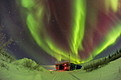 This is the sky-filling aurora of February 10, 2024, over the Churchill Northern Studies Centre, in Churchill, Manitoba, Canada. This was a Kp4-level display, though that was an unexpected level of activity this night. Predictions had been calling for only Kp1 or 2 at best. The aurora was bright enough to light the snow green.