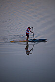 Standup paddleboarding at sunset in Ebro River, Zaragoza, Spain