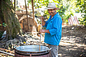 Man making homemade Pork Rind in his home in Hoja Blanca, Guatemala