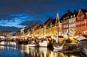 Colourful buildings and tall masted boats on the waterfront at Nyhavn at night, Nyhavn Canal, Nyhavn, Copenhagen, Denmark, Europe