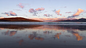 Sunrise over the island of Taransay and the North Harris hills from Luskentyre Beach, Isle of Harris, Outer Hebrides, Scotland, United Kingdom, Europe