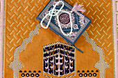 Quran and Muslim prayer beads on Islamic prayer mat with the Kaaba, Symbol of Islam, Chau Doc, Vietnam, Indochina, Southeast Asia, Asia