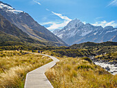 Boardwalk on the Hooker Valley Track and Aoraki (Mount Cook) in the distance, Southern Alps, South Island, New Zealand, Pacific