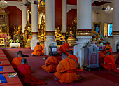 Monks praying and chanting at a Buddhist temple in Chiang Mai, Thailand, Southeast Asia, Asia