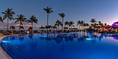 View of hotel pool and sea at dusk near Puerto Morelos, Quintana Roo, Caribbean Coast, Yucatan Peninsula, Riviera Maya, Mexico, North America