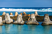 Woman on tetrapods on Yonaguni Island, Yaeyama Islands, Japan, Asia