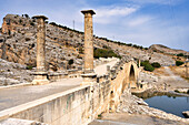 The 2nd century AD Severan Roman Bridge on the Cendere River with the columns of the Roman Emperor Septimus Severus and Empress Julia Domna, Turkey, Asia Minor, Asia