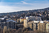 Panoramic landscape with hill houses in winter with melting snow on rooftops, Budapest, Hungary, Europe