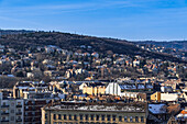 Panoramic landscape with hill houses in winter with melting snow on rooftops, Budapest, Hungary, Europe